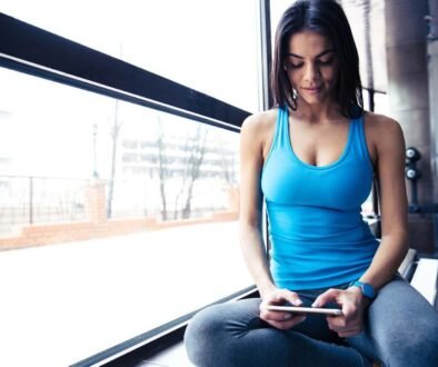 Portrait of a fit woman using smartphone